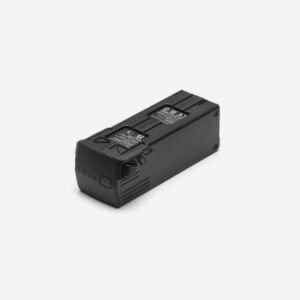 A pair of DJI Mavic 3 Series flight batteries, one standing and one flat, displayed on a glossy black surface with a folded DJI Mavic 3 Cine drone blurred in the background